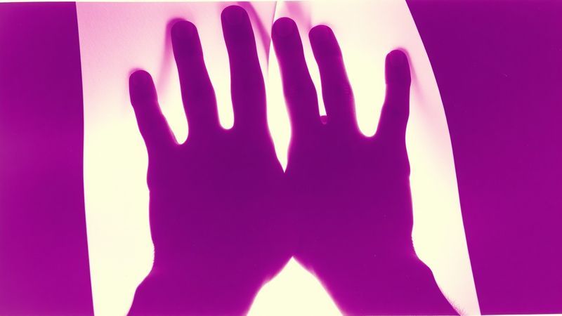 xerox zine photocopy distortion of hands pressed upward against translucent paper from below depicting hands pressed upward against translucent paper from below