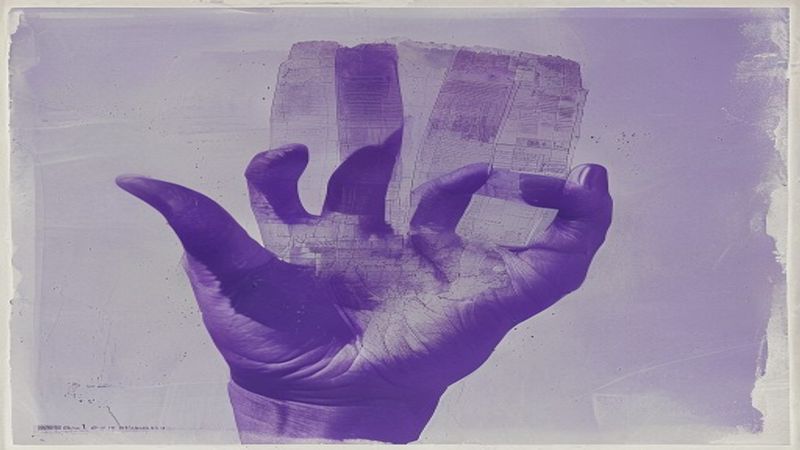 Mimeograph ghost-print aesthetic: layered purple-blue impressions of a hand holding a GPS device that's simultaneously a paper map illustration for The Map That Only Shows One Road