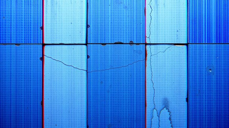 Glitch art / VHS scan-line distortion of a brutalist concrete wall with acoustic foam panels illustration for Two Rooms, One Number